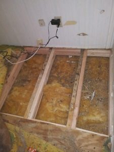 replacing flooring and securing exposed electrical outlet in mobile home